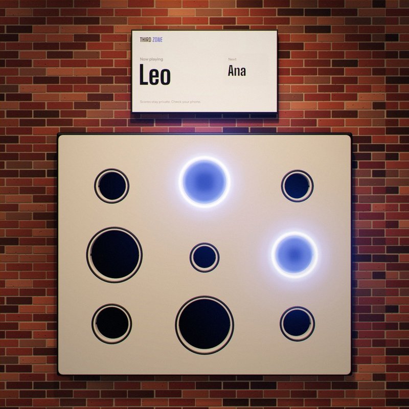 The wall with two medium targets lit. The screen above reads: Now playing, Leo.